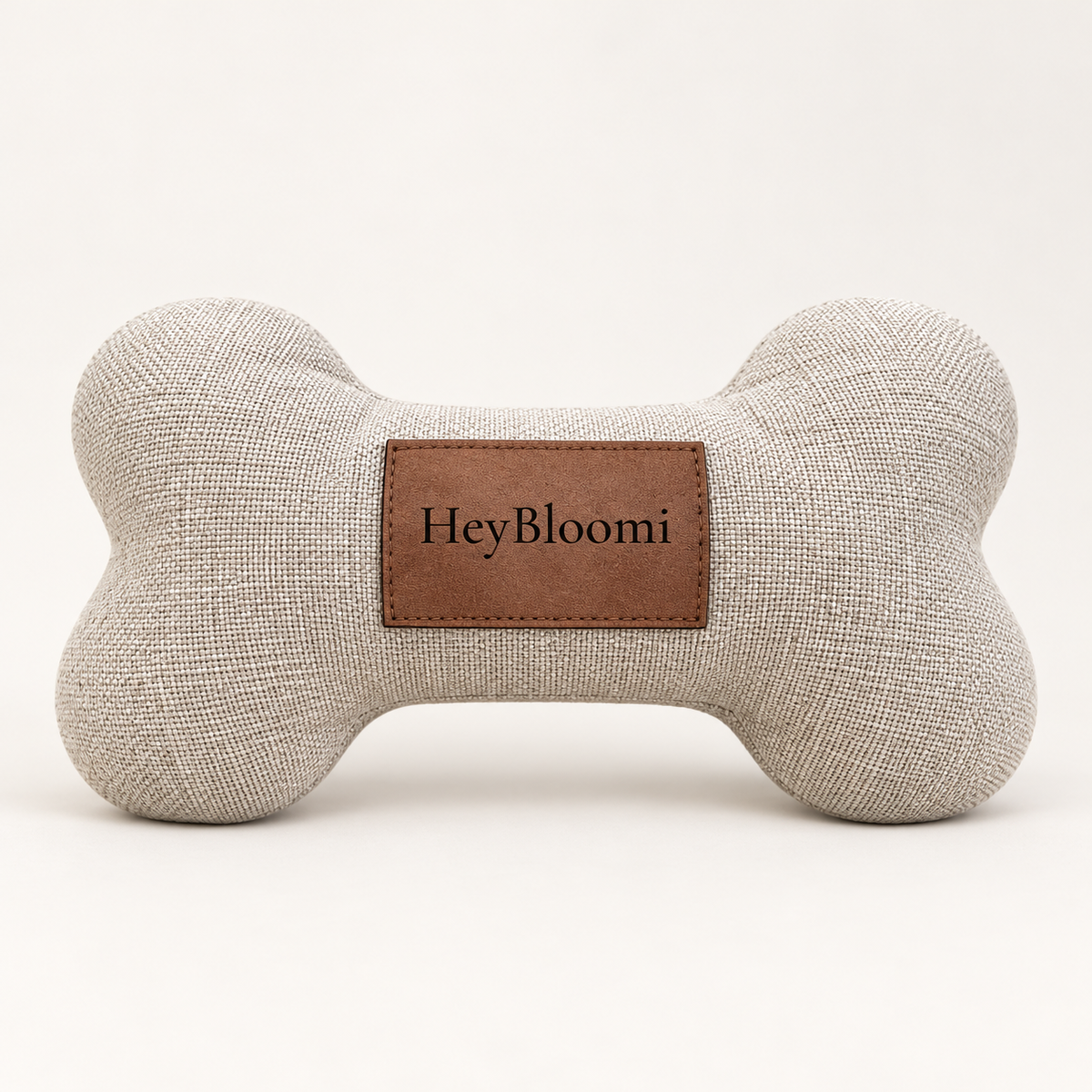 HeyBloomi Spielknochen in natürlicher Leinenoptik mit braunem HeyBloomi-Label